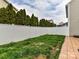 Fenced backyard with manicured evergreen trees lining the perimeter at 4708 Chantress Ln, Monroe, NC 28110