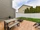 Backyard patio featuring a grill, dining table, fire pit, and fenced yard at 4708 Chantress Ln, Monroe, NC 28110