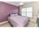 Bedroom with a lilac accent wall and a ceiling fan at 4708 Chantress Ln, Monroe, NC 28110