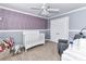 Cozy Bedroom with gray walls, a white crib, and a ceiling fan at 4708 Chantress Ln, Monroe, NC 28110