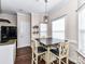 Cozy dining area with wood floors, bright windows, and stylish lighting fixture at 4708 Chantress Ln, Monroe, NC 28110