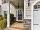 Inviting front entry featuring stone accents, classic columns, and a stylish pendant light at 4708 Chantress Ln, Monroe, NC 28110