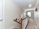 Hallway at the top of the stairs with carpet and wood railings at 4708 Chantress Ln, Monroe, NC 28110