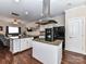 Open-concept kitchen with island, white cabinets, and hardwood floors connecting to living space at 4708 Chantress Ln, Monroe, NC 28110