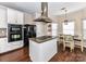 Bright kitchen with granite island, stainless steel appliances, and an adjacent dining area at 4708 Chantress Ln, Monroe, NC 28110