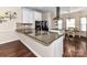 Modern kitchen featuring granite countertops, white cabinets, black appliances, and a breakfast bar at 4708 Chantress Ln, Monroe, NC 28110