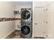 Laundry room with stacked washer and dryer for space saving at 4708 Chantress Ln, Monroe, NC 28110