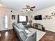 Spacious living area with hardwood floors, a large window, comfortable seating, and a ceiling fan at 4708 Chantress Ln, Monroe, NC 28110