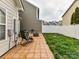 Inviting patio with tile, chair, grill, and fenced yard - perfect for outdoor entertaining at 4708 Chantress Ln, Monroe, NC 28110