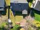 Aerial view of property showing fenced yard with mature trees, storage sheds and a small patio area at 4715 Cricklewood Ln, Charlotte, NC 28212