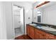 Bright bathroom with double sink vanity and tile floors, plus direct access to the shower and toilet area at 4715 Cricklewood Ln, Charlotte, NC 28212
