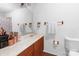 Bright bathroom featuring wood vanity, ample counter space, and a decorative mirror at 4715 Cricklewood Ln, Charlotte, NC 28212