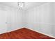 Bright bedroom with hardwood floors, a decorative chandelier, and neutral walls at 4715 Cricklewood Ln, Charlotte, NC 28212