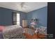 Comfortable bedroom with hardwood floors, a ceiling fan, and a charming vanity area at 4715 Cricklewood Ln, Charlotte, NC 28212