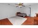 Cozy bedroom with hardwood floors, ceiling fan, and sliding glass doors to backyard at 4715 Cricklewood Ln, Charlotte, NC 28212