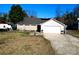 Charming single-story home featuring a covered porch, attached garage, and a spacious front yard at 4715 Cricklewood Ln, Charlotte, NC 28212
