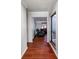 Inviting hallway with sleek hardwood floors leading to a cozy living area with plush recliners at 4715 Cricklewood Ln, Charlotte, NC 28212