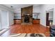 Open living room featuring a stone fireplace, built-in shelving, and sliding door access at 4715 Cricklewood Ln, Charlotte, NC 28212