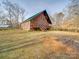 Brick home featuring a spacious deck in a serene backyard setting at 5687 Putuptoe Pl, Norwood, NC 28128