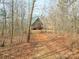 Brick house nestled in the woods with a verdant metal roof at 5687 Putuptoe Pl, Norwood, NC 28128