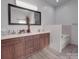 Bathroom featuring double sink vanity, a large mirror, and a separate tub at 5687 Putuptoe Pl, Norwood, NC 28128