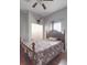Bedroom with a vintage wooden bed frame, ceiling fan, and a deer mount at 5687 Putuptoe Pl, Norwood, NC 28128