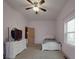 Bedroom with a white furniture set and a ceiling fan at 5687 Putuptoe Pl, Norwood, NC 28128