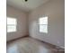 Bright bedroom with hardwood floors and two windows letting in natural light at 5687 Putuptoe Pl, Norwood, NC 28128