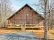 Inviting brick home featuring a charming front porch and well-maintained landscaping at 5687 Putuptoe Pl, Norwood, NC 28128