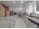 Open-concept kitchen with granite countertops, stainless appliances, and ample cabinetry for a chef's delight at 5687 Putuptoe Pl, Norwood, NC 28128