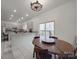 Inviting kitchen with modern appliances, ample counter space, and an adjacent dining area, perfect for Gathering meals and entertaining at 5687 Putuptoe Pl, Norwood, NC 28128