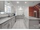 Well-appointed kitchen boasts granite countertops, modern appliances, and seamless integration with the dining area at 5687 Putuptoe Pl, Norwood, NC 28128
