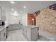 Bright, airy kitchen featuring granite counters, tile floors and a stone wall creating a rustic yet modern space at 5687 Putuptoe Pl, Norwood, NC 28128
