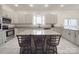 Modern kitchen features granite countertops, stainless steel appliances, and a large island, ideal for cooking and gatherings at 5687 Putuptoe Pl, Norwood, NC 28128