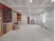 Unfinished living room with stone pillar and wood ceiling accents at 5687 Putuptoe Pl, Norwood, NC 28128