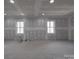 Unfinished living room featuring drywall, recessed lighting and two windows at 5687 Putuptoe Pl, Norwood, NC 28128