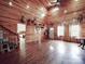 Spacious living room with wood floors, walls, and natural light from multiple windows at 5687 Putuptoe Pl, Norwood, NC 28128
