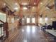Spacious wood-paneled living room with high ceilings, natural light, and unique decor; perfect for entertaining or relaxing at 5687 Putuptoe Pl, Norwood, NC 28128