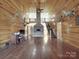 This expansive living room features wood floors, a stone fireplace, and unique decor at 5687 Putuptoe Pl, Norwood, NC 28128