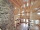 The living room features wood floors and a towering stone fireplace at 5687 Putuptoe Pl, Norwood, NC 28128