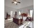 Serene main bedroom features hardwood floors, a ceiling fan, and plenty of natural light, creating a relaxing retreat at 5687 Putuptoe Pl, Norwood, NC 28128