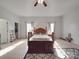 Spacious main bedroom with hardwood floors, ceiling fan, and natural light at 5687 Putuptoe Pl, Norwood, NC 28128