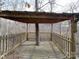 Backyard pavilion built around a tree trunk with wooden floors at 5687 Putuptoe Pl, Norwood, NC 28128