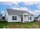 Well-maintained home with a covered patio and a spacious backyard, perfect for outdoor activities at 5712 Skinny Ln, Charlotte, NC 28215