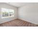 Bright bedroom with neutral walls, plush carpeting, and a window offering ample natural light at 5712 Skinny Ln, Charlotte, NC 28215