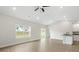 Bright living space with ample natural light, neutral walls, and hardwood flooring at 5712 Skinny Ln, Charlotte, NC 28215