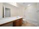 Neutral-toned bathroom with dark wood vanity, white sink, shower, commode, and large mirror at 576 Putting Dr, Fort Mill, SC 29715