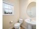 Neutral half bathroom with pedestal sink, toilet, window, and base molding at 576 Putting Dr, Fort Mill, SC 29715