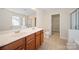 Well-lit bathroom boasts double sinks, tile flooring, and separate shower and toilet areas at 576 Putting Dr, Fort Mill, SC 29715
