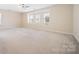 Spacious carpeted bedroom features a ceiling fan and plenty of natural light from the three windows at 576 Putting Dr, Fort Mill, SC 29715